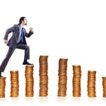 Businessman climbing gold coins stacks